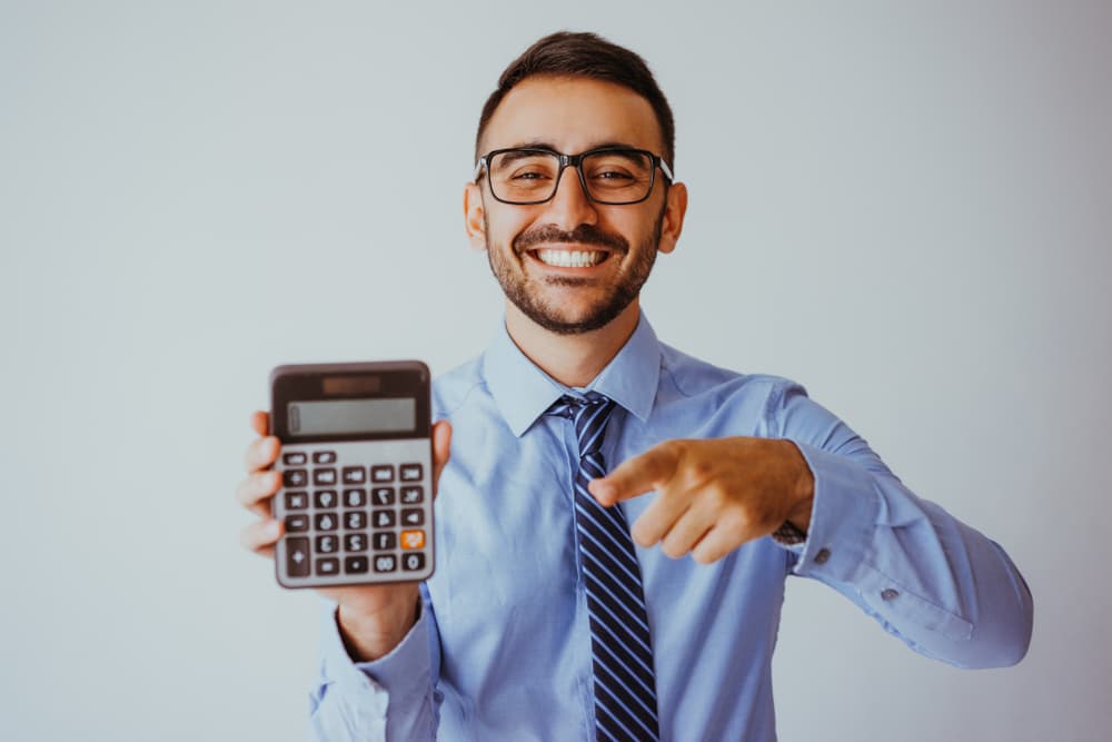 Patient smiling holding a calculator