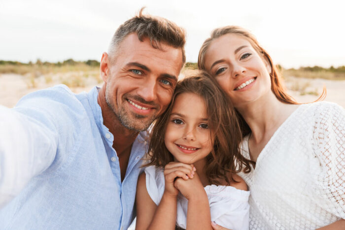 Family enjoying the beach without glasses or contacts