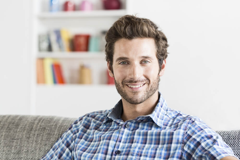 Man in his 30s sitting in modern living room