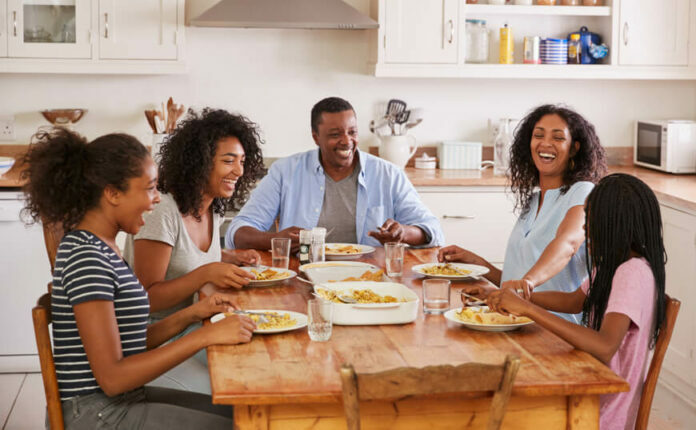 Family around the breakfast table laughing